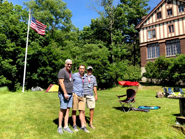 The Sigma Nu backyard with flagpole. Mickey Harris '84, Matt Wiant '84, and John Kowalchik '84